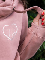 Close up of Womens Cowl Neck Hoodie - Dusty Pink ladies hoodie with rose gold metallic love heart motif and the word love in script font inside. Long sleeves and thumb loops to cuffs.