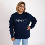 Asian lady with bob hair cut wears a Womens navy blue relaxed fit french slogan sweatshirt jumper with crew round neck and long sleeves with cuffs. 