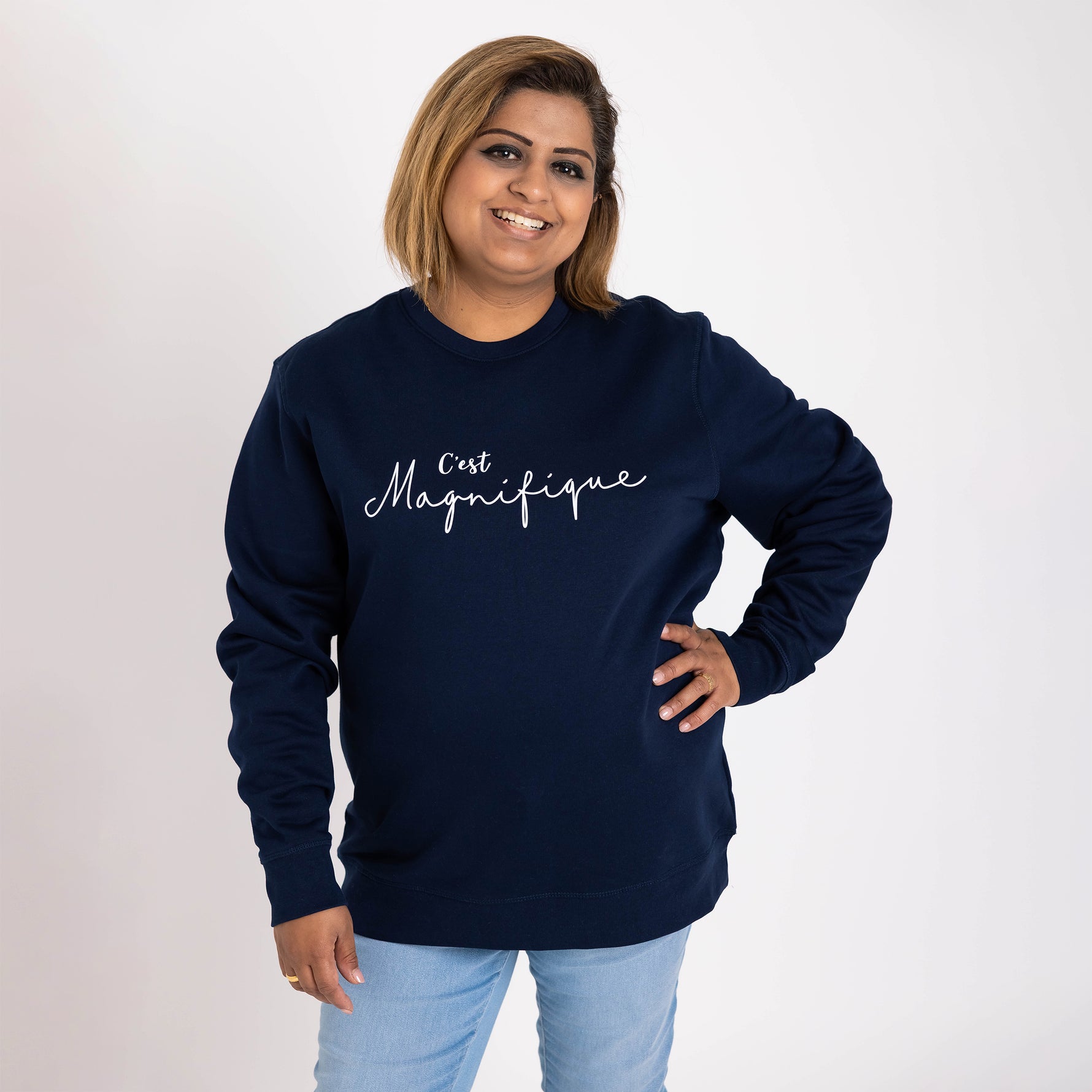 Asian lady with bob hair cut wears a Womens navy blue relaxed fit french slogan sweatshirt jumper with crew round neck and long sleeves with cuffs. 