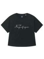 Black womens T-Shirt with dolman sleeve, rib neck collar and sleeve cuff fold. Oversized ladies t-shirt with a short sleeves, inspired by the 1990s fashion trend. White slogan script font design reads French phrase C'est Magnifique