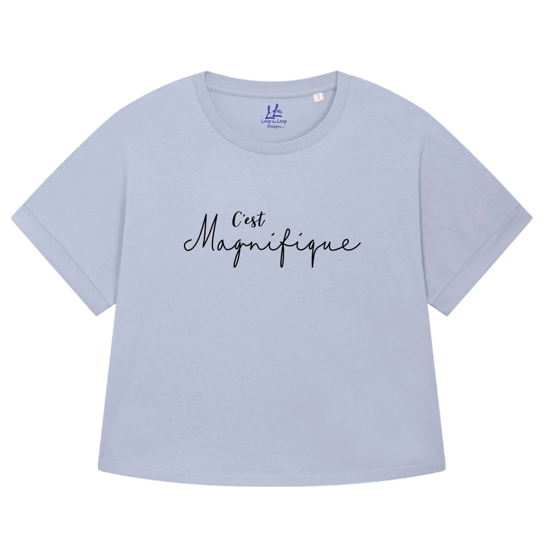 Serene light blue ladies T-Shirt with dolman sleeve, rib neck collar and sleeve cuff fold. Oversized women’s t-shirt with a short sleeves, inspired by the 1990s oversize trend.. Black slogan script font design reads French phrase C'est Magnifique