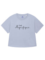 Serene light blue ladies T-Shirt with dolman sleeve, rib neck collar and sleeve cuff fold. Oversized women’s t-shirt with a short sleeves, inspired by the 1990s oversize trend.. Black slogan script font design reads French phrase C'est Magnifique