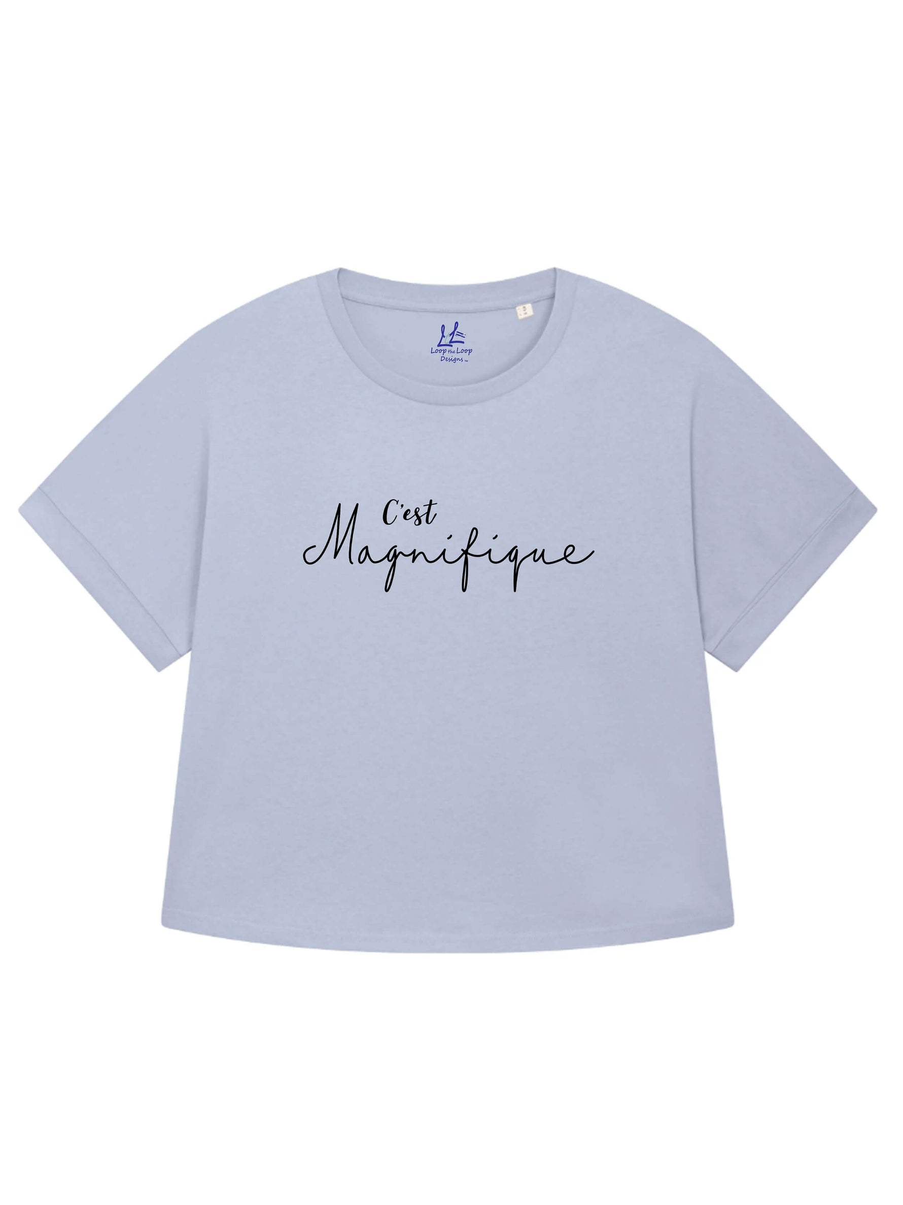 Serene light blue ladies T-Shirt with dolman sleeve, rib neck collar and sleeve cuff fold. Oversized women’s t-shirt with a short sleeves, inspired by the 1990s oversize trend.. Black slogan script font design reads French phrase C'est Magnifique