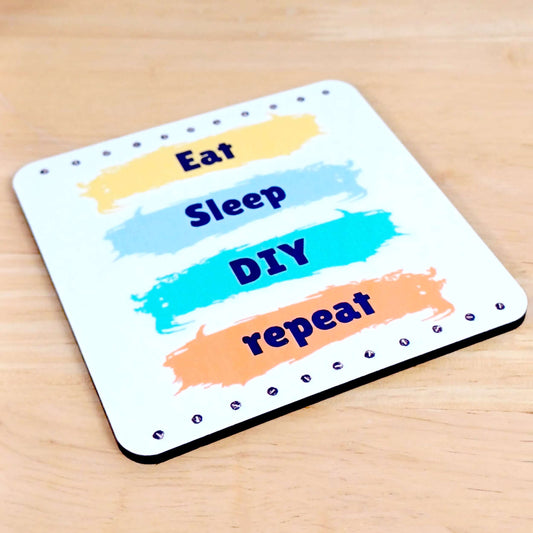 Gift for Dad or DIY enthusiast. White square wooden coaster with screws and paint stripes design. Each stripe of paint has a word in vertical sequence. Eat Sleep DIY repeat. Perfect Birthday or Father's Day gift idea