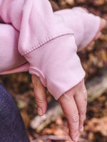 Close up of thumb loops of ladies fashion hoodie. baby pink womens hoodie Love heart cross cowl neck casual fashion hoodie. Cotton Polyester blend relaxed fit unisex oversized style hoodie design has love heart. Whitert to upper left of the chest with word Love in 