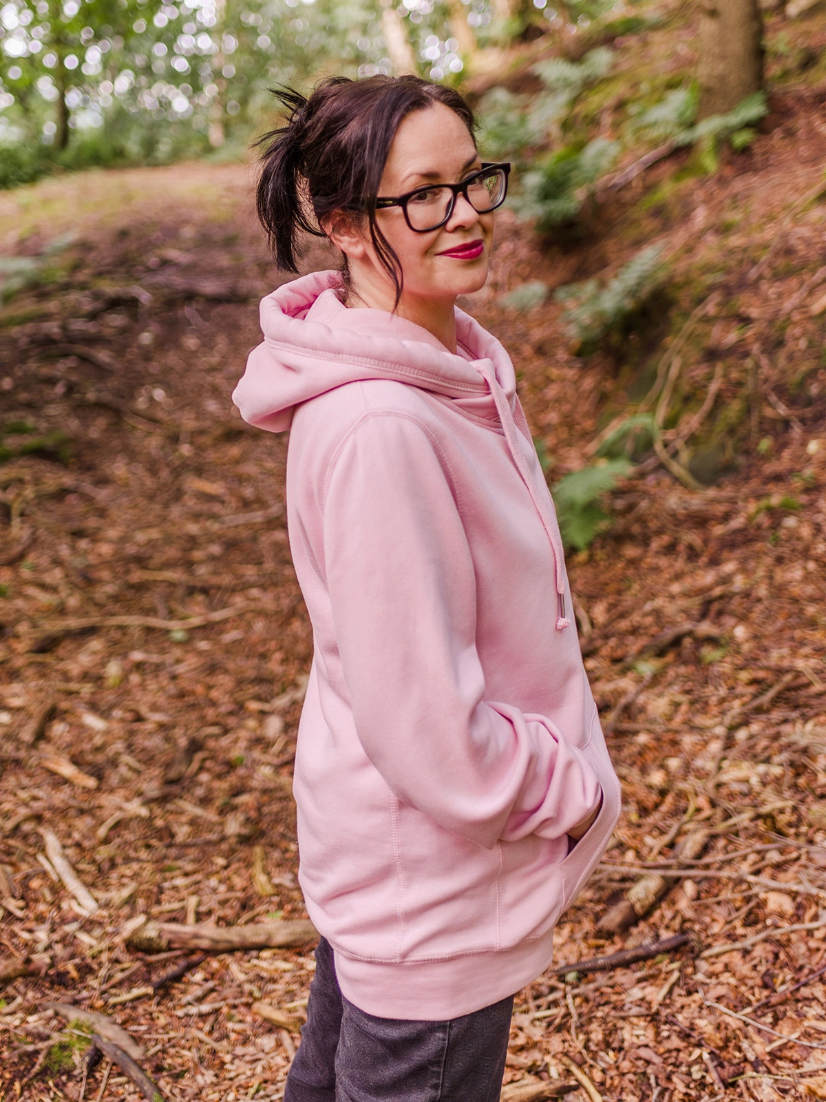 Womens cowl neck hoodie.  Woman wears baby pink womens hoodie Love heart cross cowl neck casual hoodie. Cotton Polyester blend relaxed fit unisex oversized style hoodie design has love heart. 