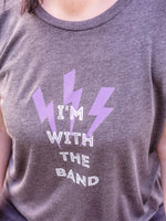 Close up of graphic t shirt design. Summer Festival Women's Band Tee. Ladies T shirt Grey cotton cap sleeve t shirt with lightning bolt design and slogan I'm with the Band. Lilac lightning bolts x3 and white slogan distressed look text in upper case lettering