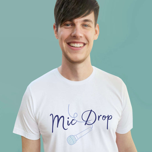 Man with brown short hair wearing a Mens white graphic tshirt with wording Mic Drop and blue microphone outline. Music theme unisex relaxed fit crew neck slogan