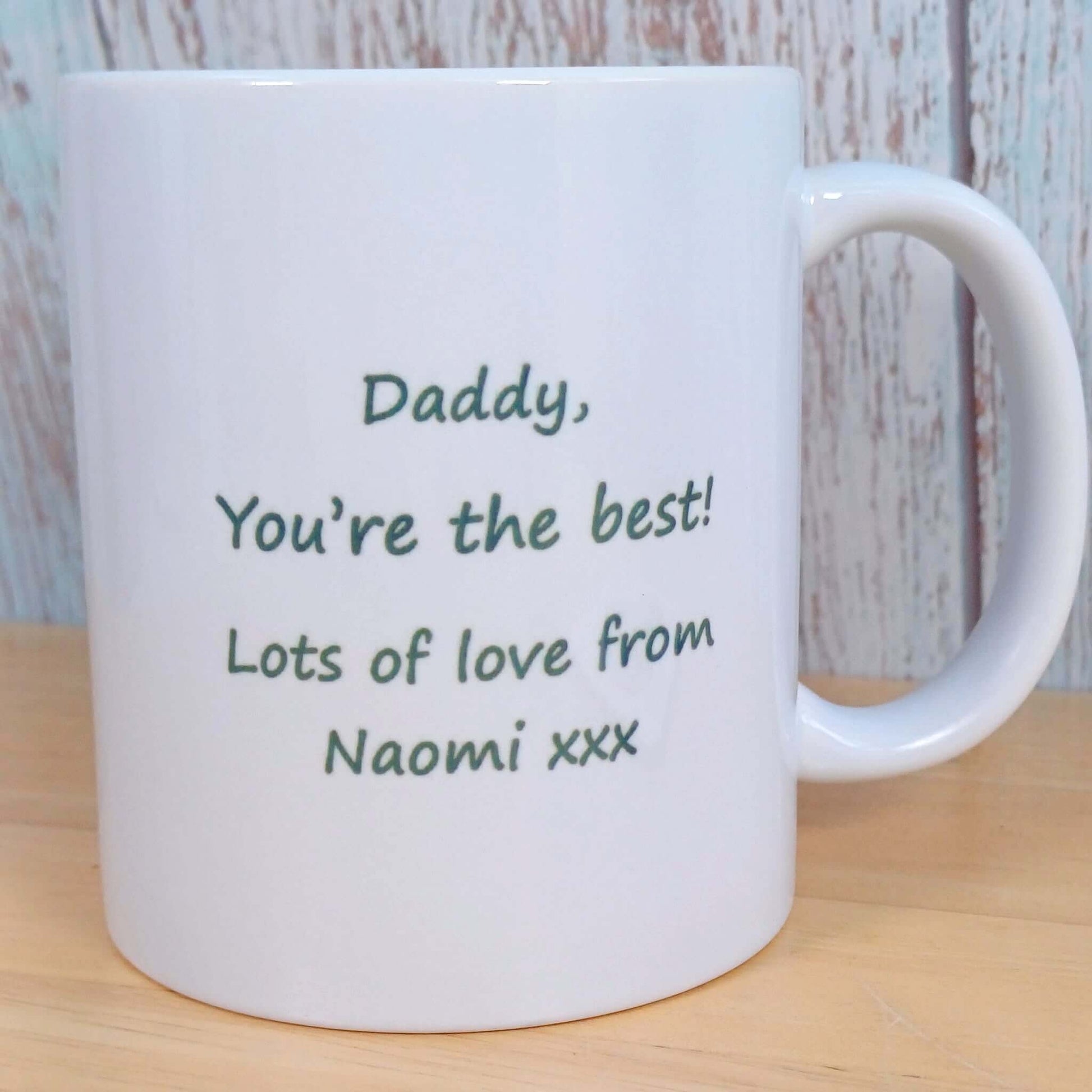 Gift for Cycling Enthusiast. Personalised Mug with Daddy gift message. Other side of mug matches coaster, not seen, has Green Heart & white heartbeat across turning into white cyclist bike. Wording Always choose the Scenic Route in green script font
