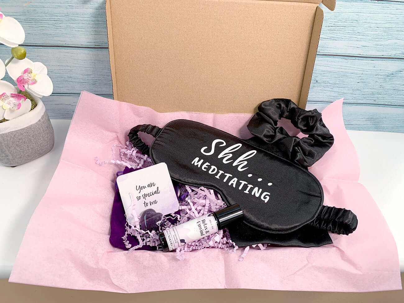 Crystal and essential oil boxed gift set. Black sleep mask with wording 'Ssh...Meditating'. Amethyst gemstone keepsake with velvet pouch
