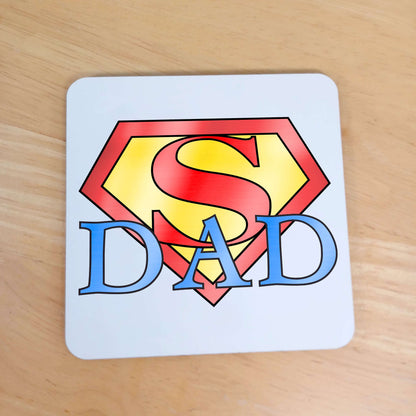 Birthday or Father's Day Gift for Dad - Superhero themed coaster. White wooden coaster with red and yellow Superman Logo design with blue wording " Dad " intertwined underneath