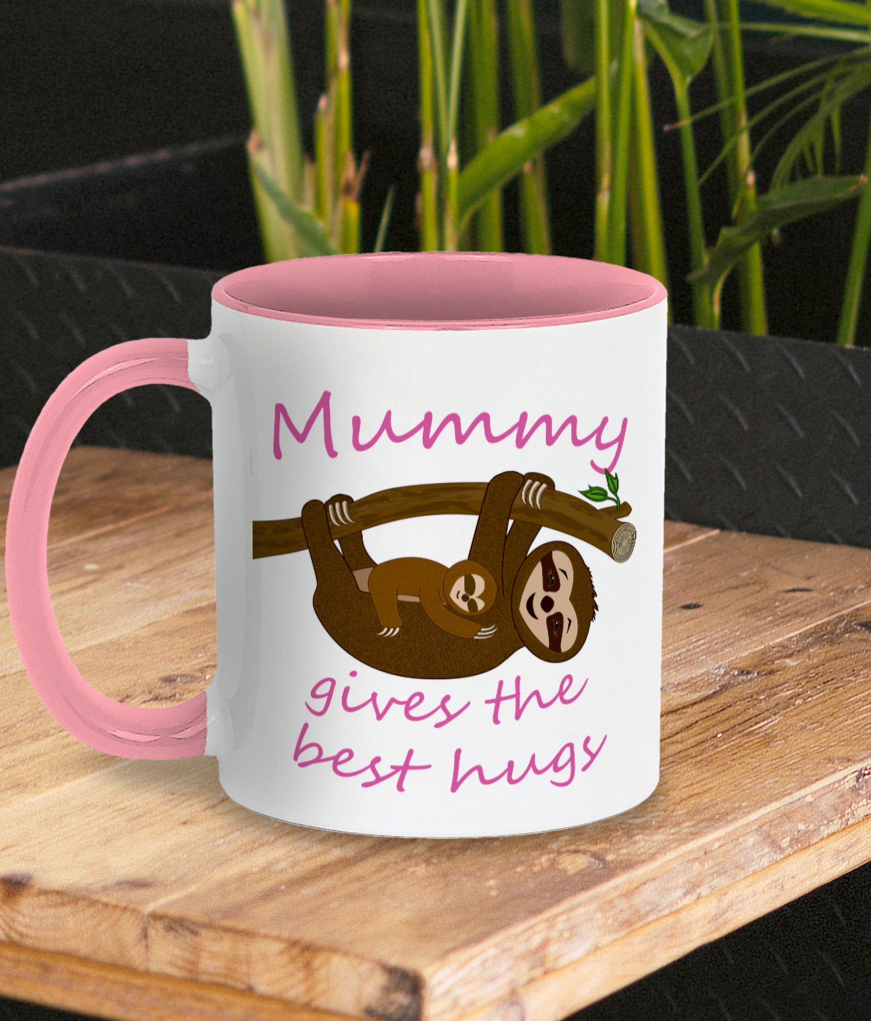 Personalised Tea / Coffee cup gift. Cute cuddly three toed sloths on a branch. Mum and baby. Two tone white with pink ceramic coffee mug. Customisable name reads Mummy gives the best hugs in pink font. Same design on both sides of mug shown by photo.