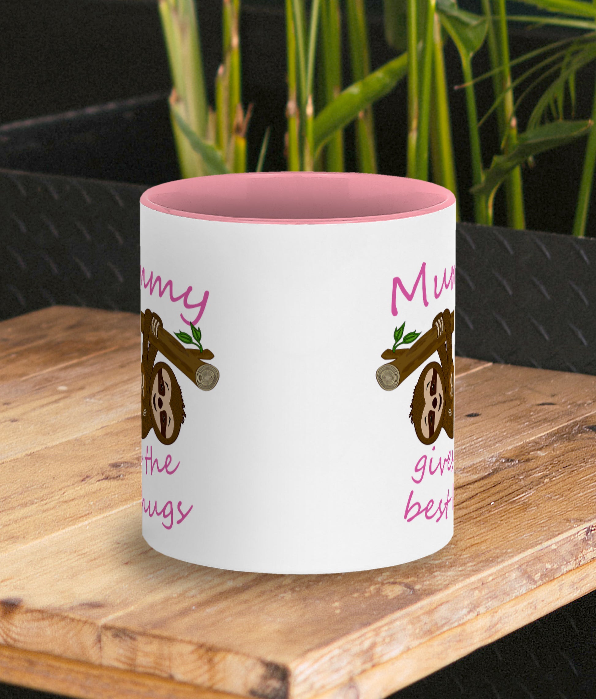 Personalised Tea / Coffee cup gift. Cute cuddly three toed sloths on a branch. Mum and baby. Two tone white with pink ceramic coffee mug. Customisable name reads Mummy gives the best hugs in pink font. Same design on both sides of mug shown by photo.