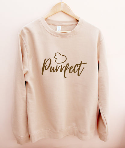 Cat lover top - Beige / Caramel colour relaxed fit long sleeve sweatshirt on wooden hanger Slogan sweater design wording Pawfect in brown font and brown heart outline above with cat 4 sequenced paw print within outline.